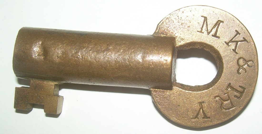 Missouri Kansas Texas Brass Switch Key: Not maker marked but definitely a Slaymaker product. Standard fat barrel with “S”witch bit. Serial number of “22099” on the reverse. One small dent to barrel.