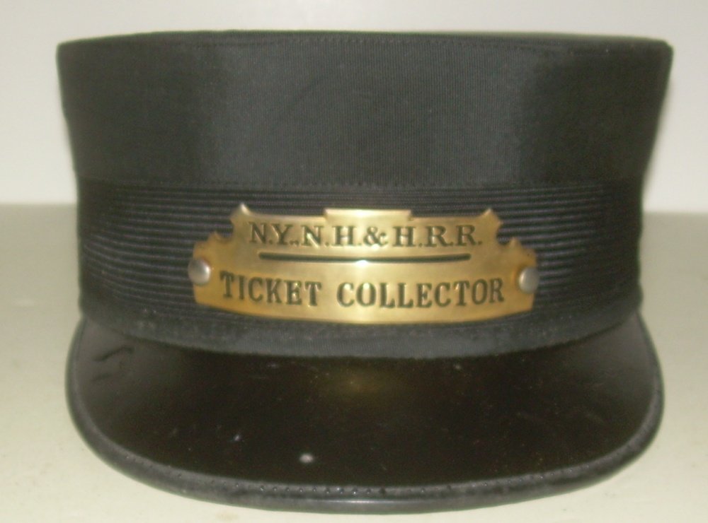 New Haven Ticket Collector Hat with Badge: Standard NYNH&HRR initials with the Ticket Collector occupation spelled out. The hat is a size 7 1/8. The hat was made by Wentworth in Boston.