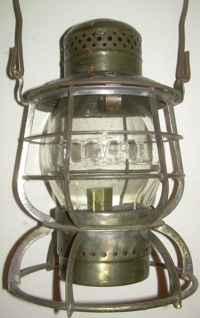 LVRR Armspear Lantern Cast LVRR Globe: Lehigh Valley lid stamped Armspear with drop in fount and original brass burner. The frame has flat vertical wires. Nice LVRR cast is a square end panel on the globe. The globe also has the Corning "C