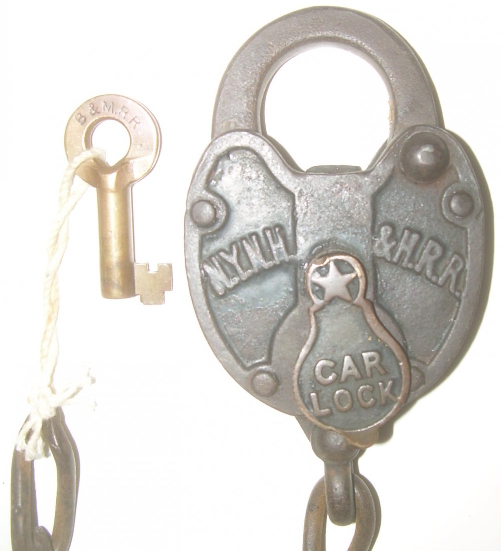 New Haven Cast Car Lock & B&M Switch Key: New Haven cast “C”ar lock. Standard cast iron plates with brass un-sprung dust cover. Several links of hand forged chain. Included is a B&M switch key that the consignor thought tripped the lock b