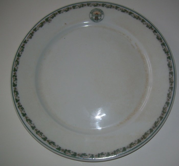 Southern Pacific "Sunset" Large Dinner Plate: Measures 9 3/4" in diameter. Madocks hallmark on reverse. Sits flat as a pancake. One detracting pimple at 11:00 near logo. Browning on right top food well edge. Still a tough large plate to find.