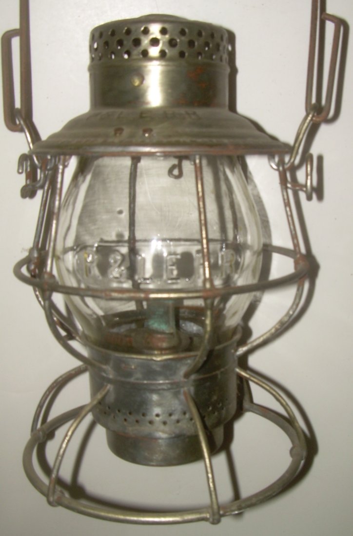 Pittsburg & Lake Erie Railroad Lantern Cast Globe: An Adlake Reliable frame with P&LE stamped in the lid. The globe also has the Pittsburg & Lake Erie initials in a bold casting. It's a standard Reliable frame with 2 horizontal wires and a single piec