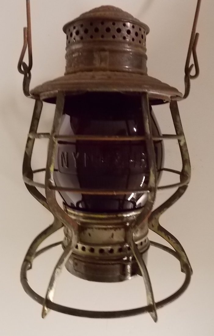 New Haven A&W “Beehive” Lantern Red Cast Globe: The New Haven NYNH&HRR initials are stamped in the lid of this Adams & Westlake "bee hive" style lantern. This early frame has a ratchet down top instead of a retaining spring. There is surface rust b