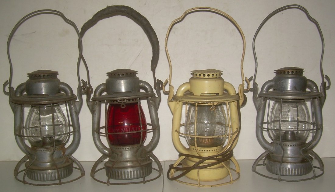 4 New Haven Dietz Vesta Lanterns: A group of 4 Dietz Vesta lanterns all have NYNH&H stamped on the lids. (1) clear unmarked globe with date code of S-10-52. (2) red etched NYNH&H globe with date code of S-11-40. (3) painted yellow wit