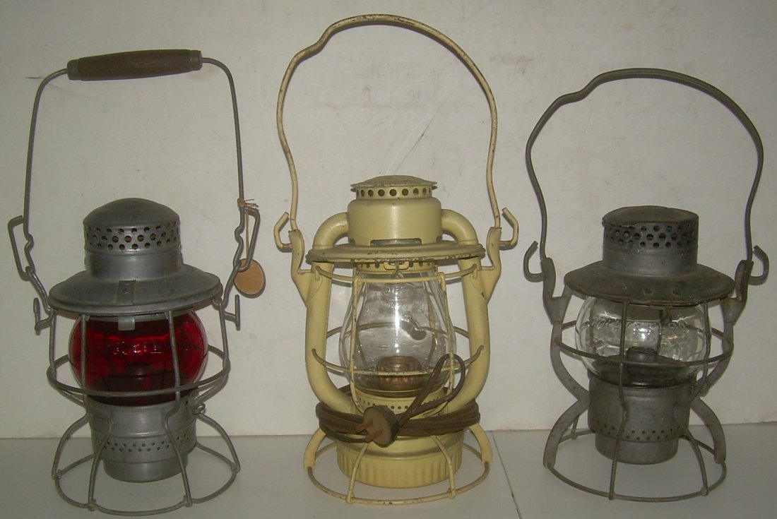 3 Lanterns: CPR, NYCS, NYCS: 3 short globe lanterns: (1) Canadian Pacific with wooden bail – clear unmarked globe (2) New York Central Dietz Vesta – clear etched B&MRR globe with flaw from touching another globe when fired (3