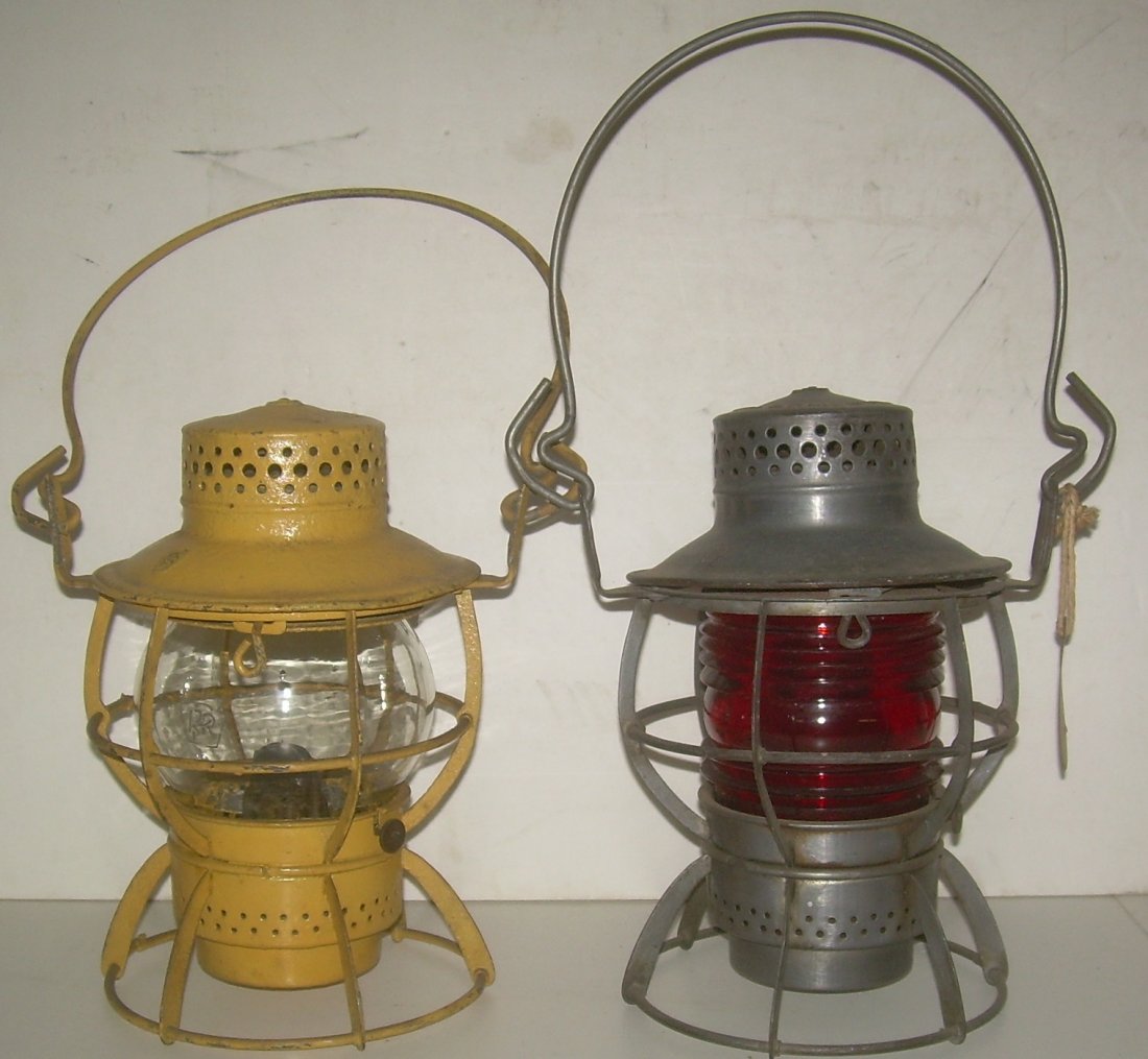 2 Pennsylvania Railroad lanterns Clear Red Globes: A group of 2 Pennsy Dressel lanterns both with the PRR Keystone logo stamped in the lids. The yellow painted one has a nice Keystone logo etched globe. The unpainted has a Fresnel red globe.