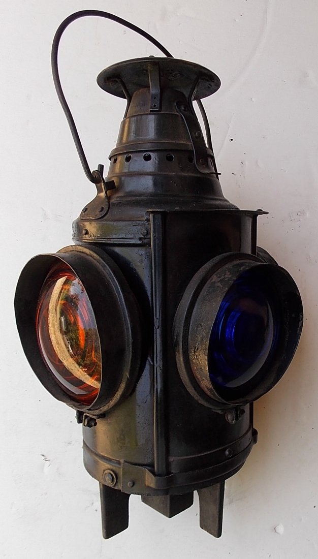 New Haven Dressel Switch Lamp with Hoods: A Dressel switch lamp made for the New Haven Railroad. This lamp has hoods appli8ed to the lens openings. It has "NH" cast up in the mounting post. This is next to impossible to photograph. It has len