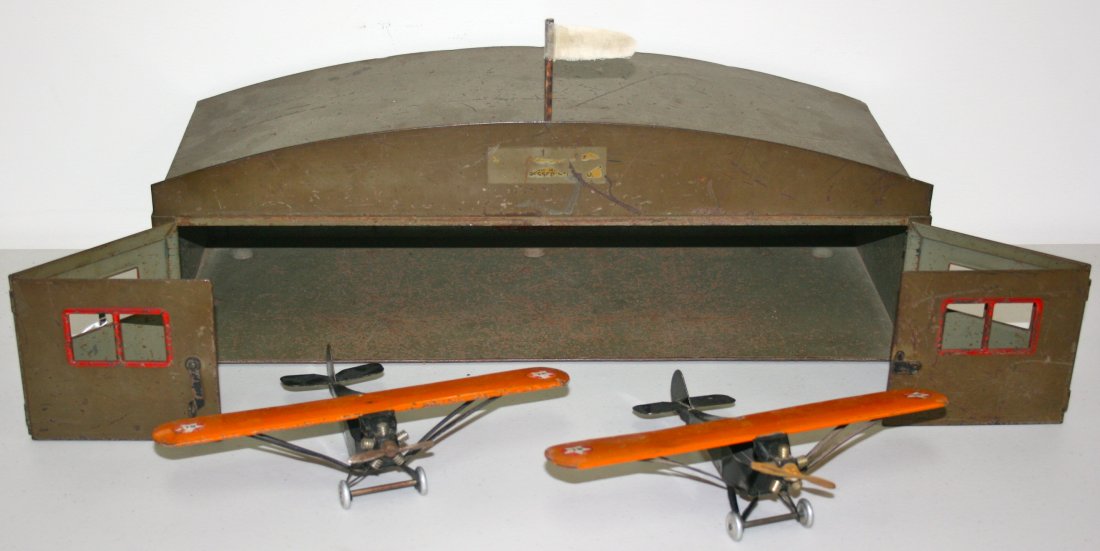 Buddy L toy airplane Hanger and two airplanes: Buddy L toy pressed steel Airplane Hanger with Two Buddy L Airplanes, pressed steel, Marked BL-12. Hanger 20"lx7"h, Planes 10"wingspanx2.25"hx6.5"l