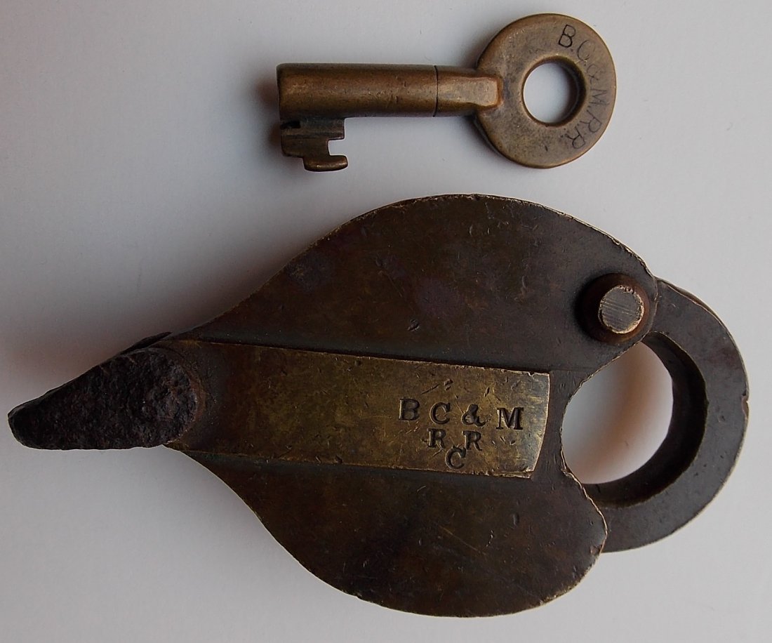 Boston Concord & Montreal Railroad Car Lock & Key: A very nice set. The lock is an earlier Sherburne example. The lock does not have the seal hole sometimes found on box car locks. The dust cover is nicely sprung. The lock is known to be early because