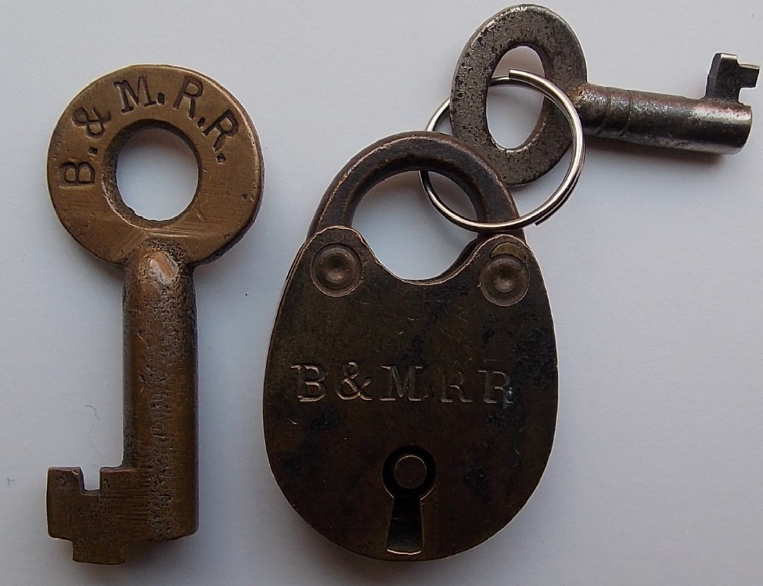 Boston & Maine tiny Lock & Key / Sherburne Key: A very unusual small brass lock that is clearly stamped B&MRR on one side. It measures just 1 3/4” tall by 1 1/4” wide. A small steel key is included. Probably used on a strong box or possibly a c
