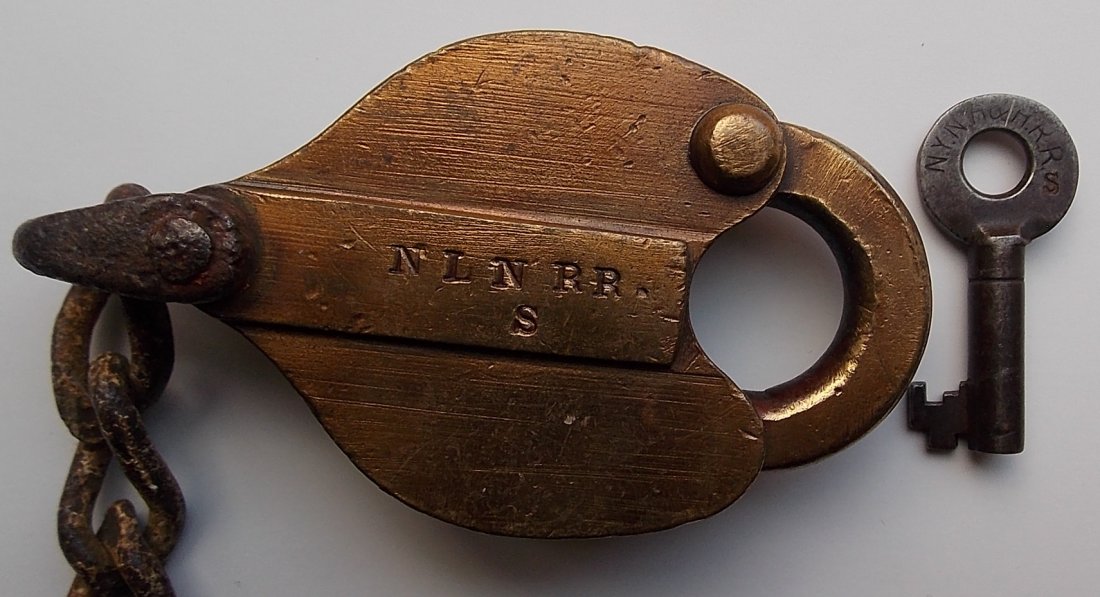 New London Northern Brass Lock NYNH&H Key: The New London Northern was a Central Vermont predecessor that operated south of Palmer Massachusetts. This is a very old S. C. Thompson lock that is clearly stamped NLN RR with an “S” added for s