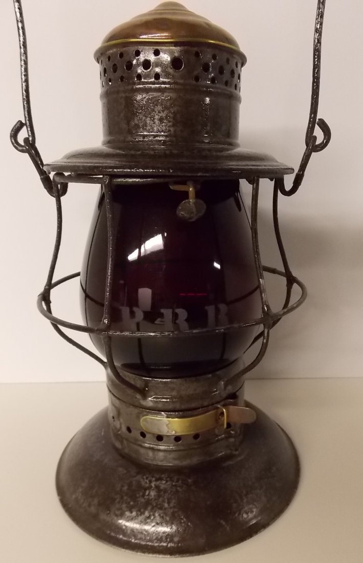 Pennsylvania Railroad Lantern Brasstop Bellbottom: The frame is a Kelly brass top with a twist off bell. The brass top is in very good shape. There is some even pitting to the lid. The lid has PRR clearly stamped on one shoulder. The bell has an Adams