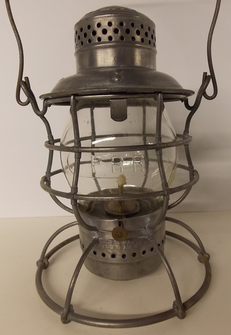 Pennsylvania Railroad Lantern Armspear PRR CC: A standard 1913 patent model “tall” Armspear lantern frame with the correct pot and burner. It is stamped PRR on the shoulder of the lid. The Armspear information is above that. They stamped the 1