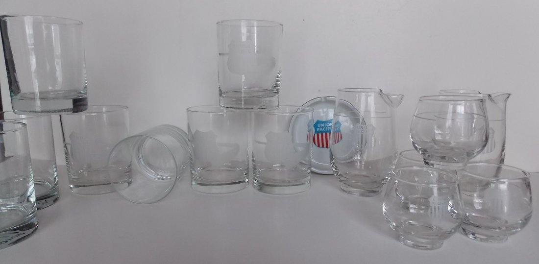 Union Pacific Railroad – Glassware (15): A group of Union Pacific glassware (and an ashtray). The glassware includes 2 similar style straight sided “rocks” glasses. You get 4 of each. One has the UP shield logo on the side and the others