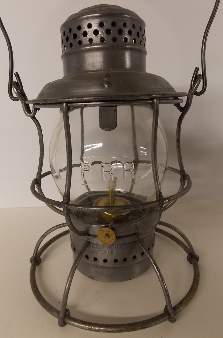 Pennsylvania Railroad Lantern Armspear PRR CC: A standard 1913 patent model “tall” Armspear lantern frame with the correct pot and brass burner. It is stamped PRR on the shoulder of the lid. The Armspear information is above that. They stamped