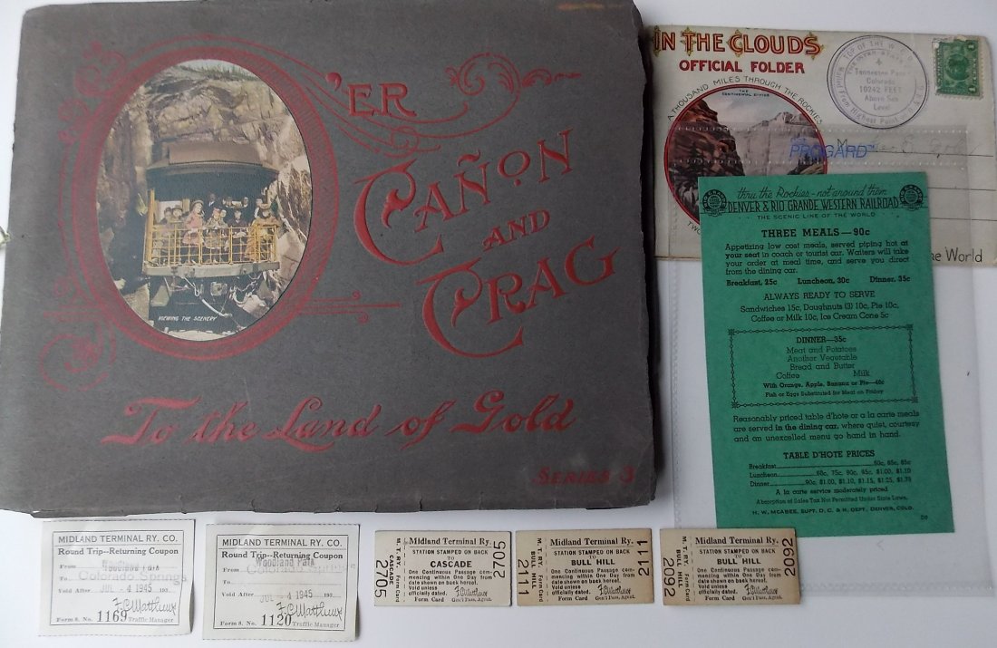 Colorado Railroad Items + 2 Books: A group of Colorado items that includes: “O'er Canon & Crag” 1904 Cripple Creek District color folio, Denver & Rio Grande Western Menu with 35 cent Dinner listed, 5 Midland Terminal tickets, “In