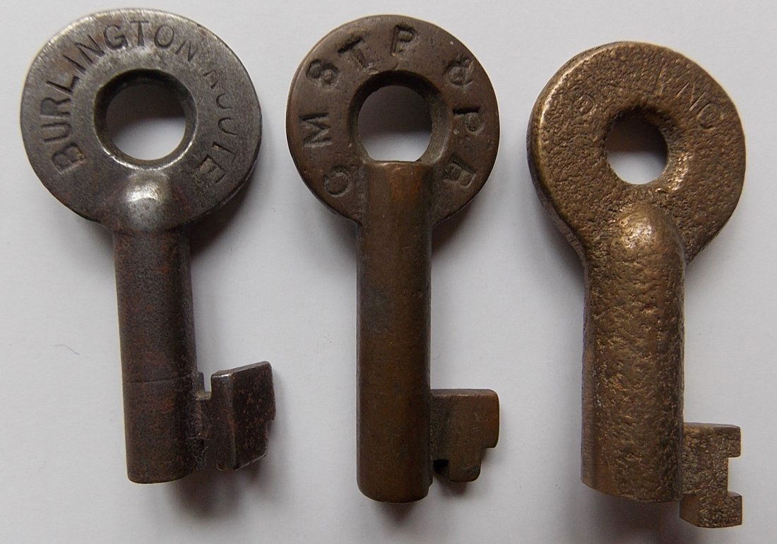 3 Railroad Switch Keys: Burlington, Milw Road, BN: A group of 3 railroad switch keys: Burlington Route spelled out in steel with A&W hex logo and “211990” and “S” on reverse (2) Chicago Milwaukee ST Paul & Pacific (3) Modern Burlington Norther