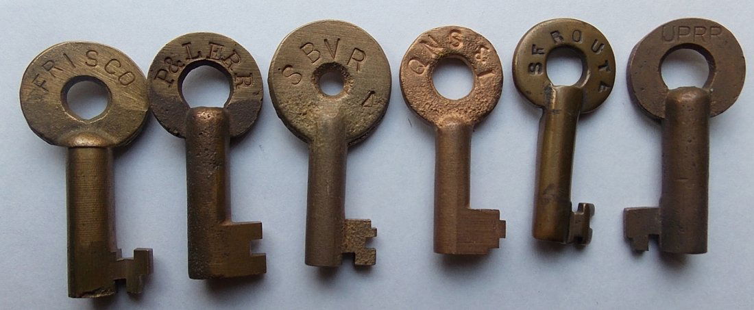 Railroad Brass Switch Keys (6) P&LE, SBNR, UP: A group of newer looking brass switch keys: FRISCO, P&LE RR, SBNR 4, QNS&L (Canada), SF Route (collapsed barrel), UPRR – various makers and markings.