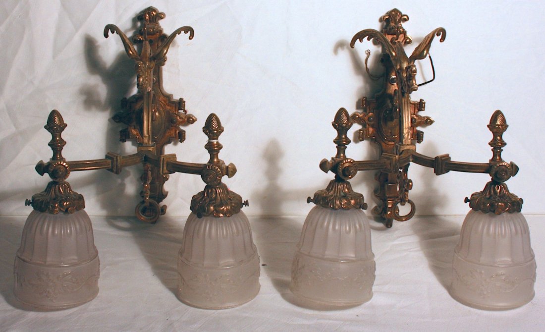 Pair of brass Wall Sconces: Two Electric Wall Sconces, brass colored, snarling dragon figures on top, overall 15"h