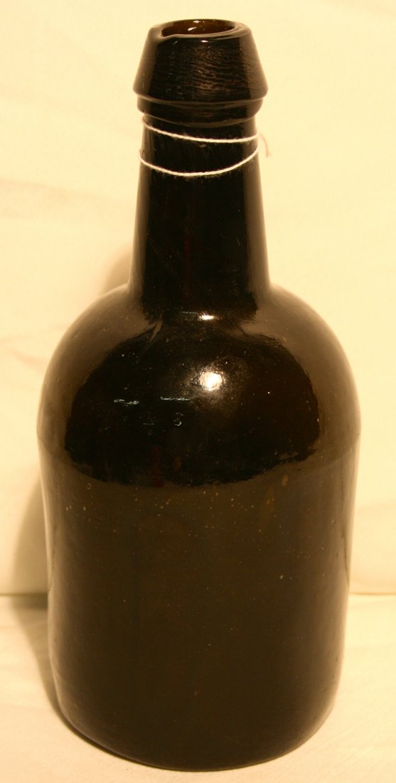 Bottle, olive green, Stoddard, NH: Bottle, olive green, has double tapered collar,bulbous shape, open pontil, single dot mark, attributed to Stoddard Glass works, Stoddard, NH 9" tall