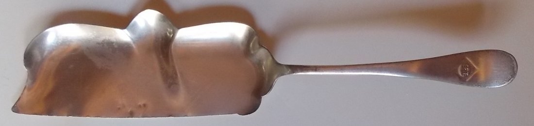 Erie Railroad Silver Crumb Scraper: Erie Railroad silver plated crumb scraper. This is a scraper used by a Porter to scrape bread crumbs off the tablecloth. It has a nice Erie diamond logo on the handle. It has some dings and a bend in 