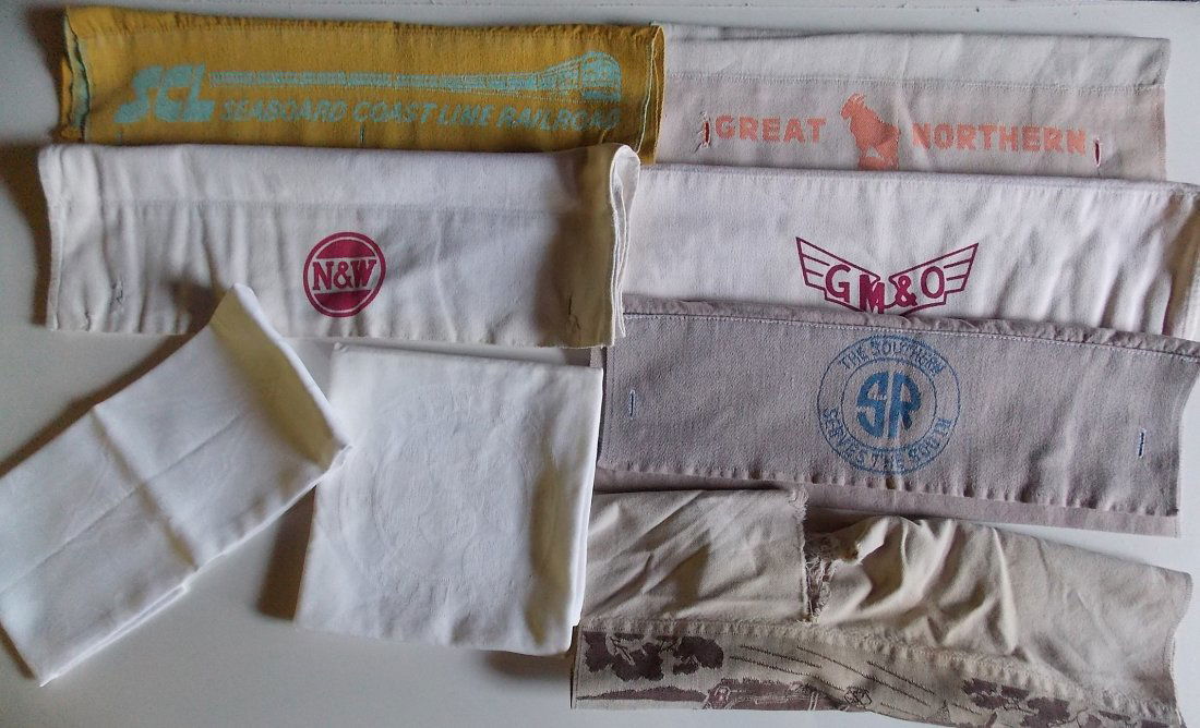 Dining Car Linens & Heasdrest Covers: This group includes Texas & Pacific Railway (22" by 15") napkin with center diamond logo and Golden State Route (21" by 21") linen napkins with center logo. 5 good headrest covers: SCL, Norfolk & West