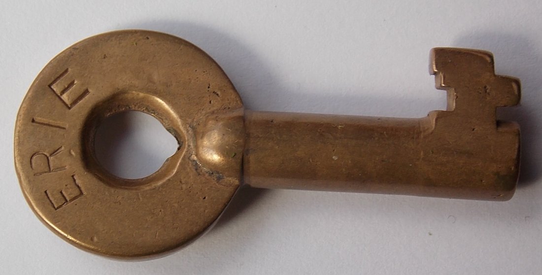 Erie Railroad Brass Switch Key - Adlake: This is a standard style Adlake key and it has "ERIE" spelled out in block lettering. It has the ADLAKE logo on the other side. It does not have an "S" but this is the Erie switch bit. Moderate use.