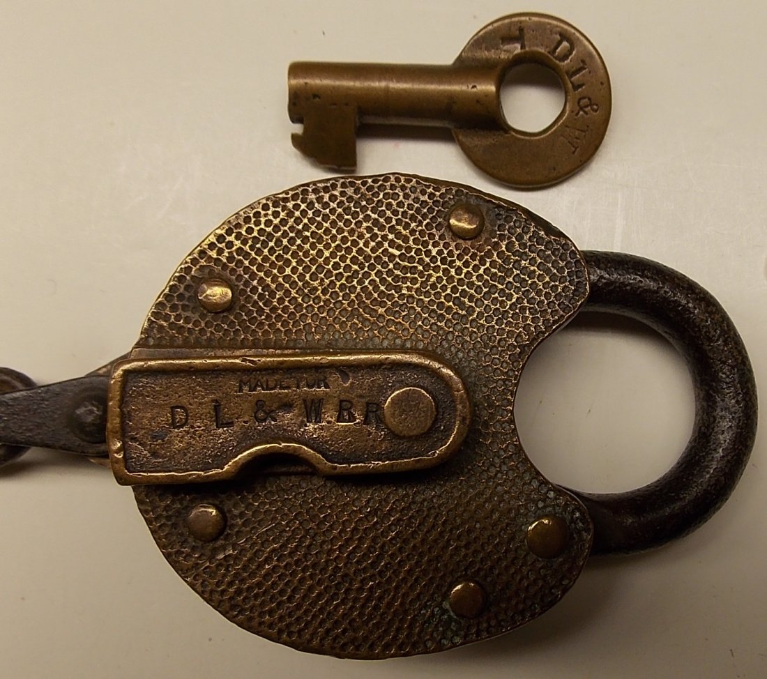 Delaware Lackawanna & Western Lock & Key: The lock is a Yale product with "Made for DL&W RR" stamped in the dust cover. The lock face and back plates have a pebble finish. The key has "DL&W T" stamped on one side and a Fraim dog-bone hallmark