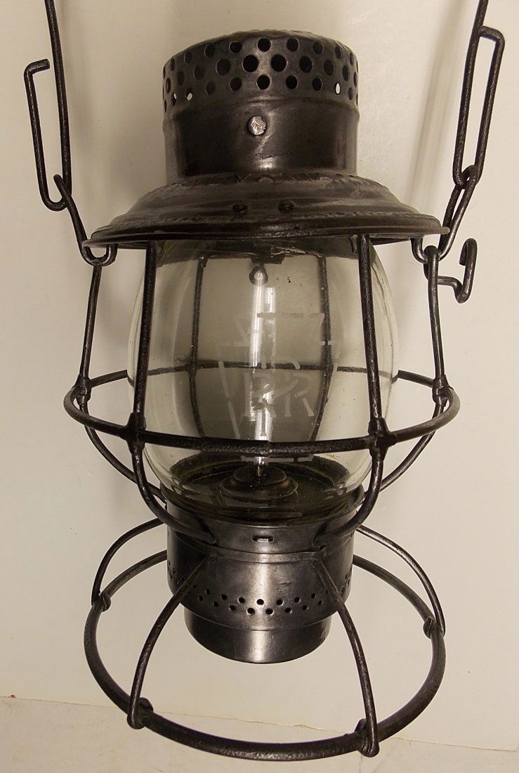 Pennsylvania Lines Reliable Lantern 2" Keystone: An Adlake "Reliable" model lantern frame with a single piece top. This frame also has the last style of burner used on Reliable models. It has a twisted wire wick adjuster and an odd plated base plate