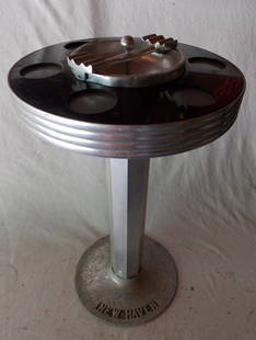 * New Haven Railroad Parlor Car Drink Stand: A New Haven Railroad drink stand ashtray combo. It stands about 25â€ tall and the top has a diameter of 15â€. It has pockets for 6 drinks. The center has a removable ashtray. The highlight is th