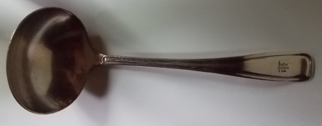 Boston & Maine Railroad Silver Ladle: This silver ladle was made by Meriden and it pairs with a covered casserole. The ladle measures 9" long and it's heavy. It has a fine "Arrow" logo on the top at the end of the handle. There is no dama