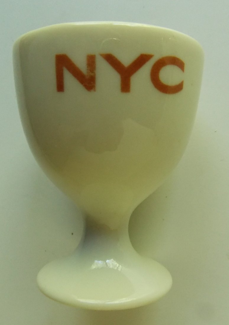 New York Central Railroad Mercury Egg Cup: A fine New York Central Railroad china egg cup in the "Mercury" pattern. It measures just 2 3/8" tall with a top diameter of 1 7/8". There is nothing on the bottom which was not glazed so this is typi