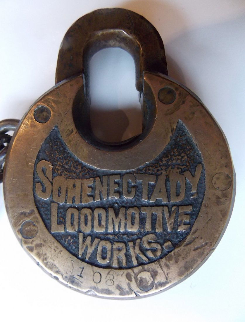 Schenectady Locomotive Co Cast Pancake Lock: A great pancake lock with the Schenectady Locomotive Company name cast across the front panel. It comes with an operating key, old attached chain. The ley works the lock just fine. This name pre-dates