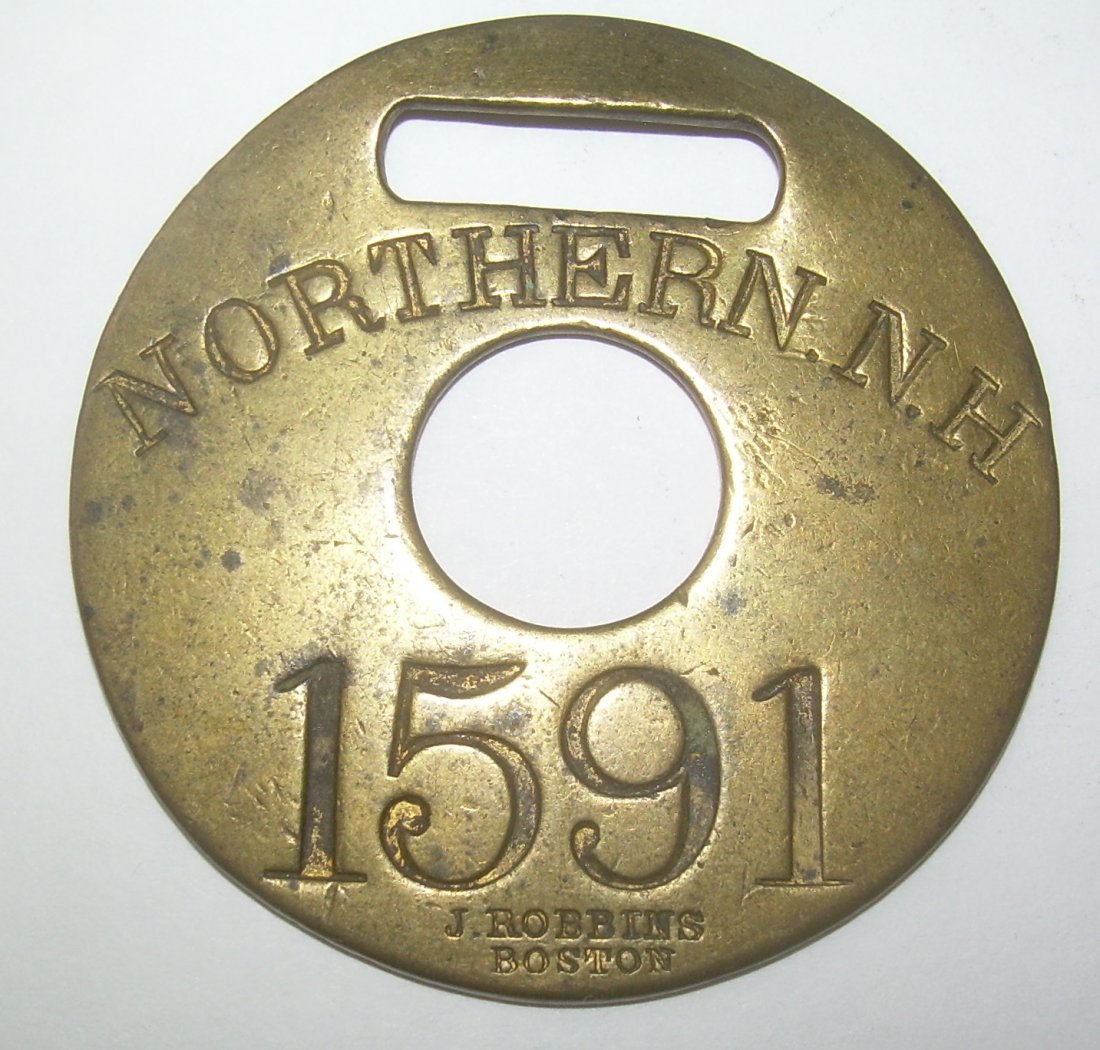 Northern Railroad of New Hampshire Baggage Tag: A nice John Robbins example with a hole in the center that is part of the original design. Nice markings with Northern in an arc and 1591 on the bottom with a John Robbins hallmark on the very bottom.