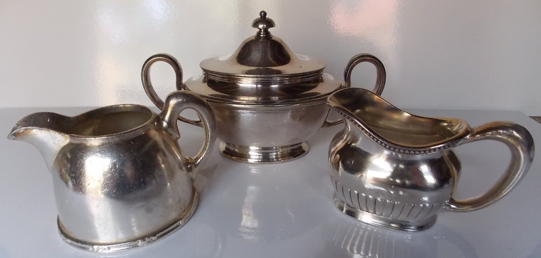 New Haven Railroad Silver Holloware (3): 3 pieces of silverplate made for the New York New Haven & Hartford Railroad. All were made by Reed & barton: (1) 8 oz creamer with narrow spout (2) covered sugar 11 oz - big (3)5 oz creamer with beade