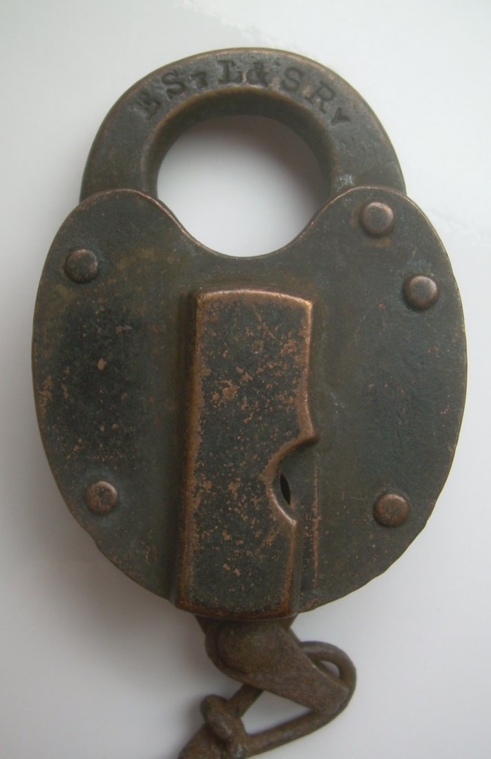 E. St Louis & Southeastern Railroad Lock: An East Saint Louis & Southeastern lock made by Fraim with their keystone logo on the shackle. It takes a big barrel ke with an odd bit. The dust cover spring is not working.