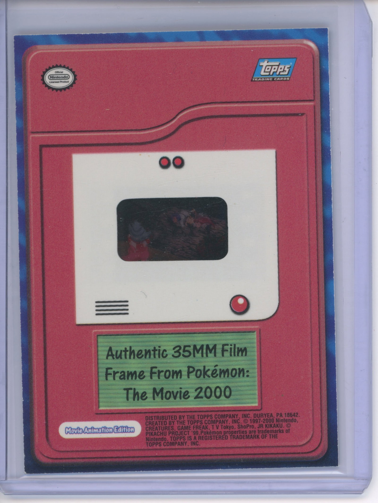 Pokemon Topps - Authentic Film Cell - Pokemon The Movie 2000: This lot features a genuine film cell from the second Pokemon movie - Pokemon The Movie 2000 depicting Team Rocket bowing to Slowking. These were exclusively found in the Topps Pokemon The Movie 2000 