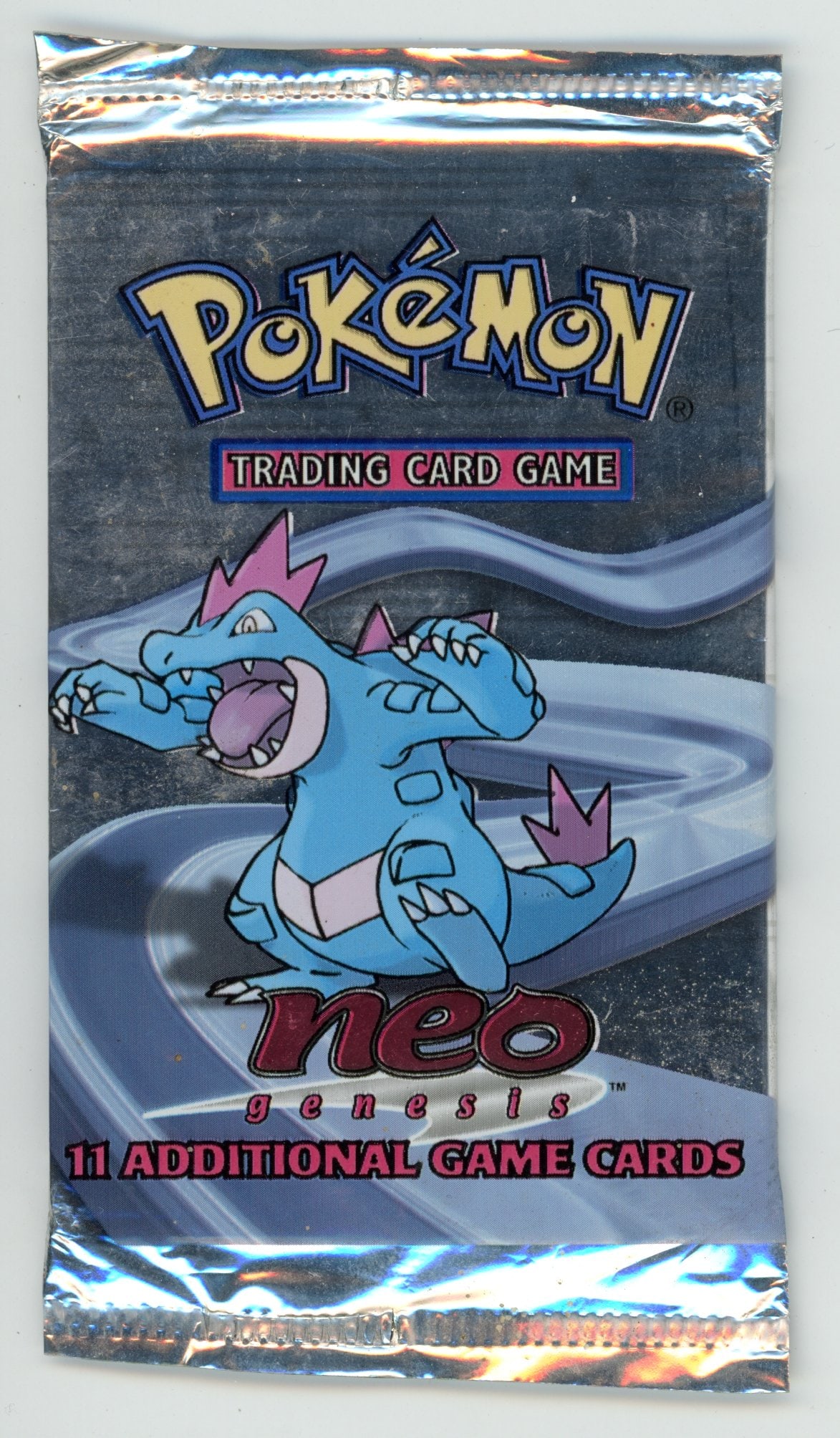 Neo Genesis Sealed Booster Pack - Feraligatr: A sealed, unweighed booster pack from the Neo Genesis expansion featuring the Feraligatr artwork in excellent condition. While light scuffing and creases can be seen, the pack has all original seals