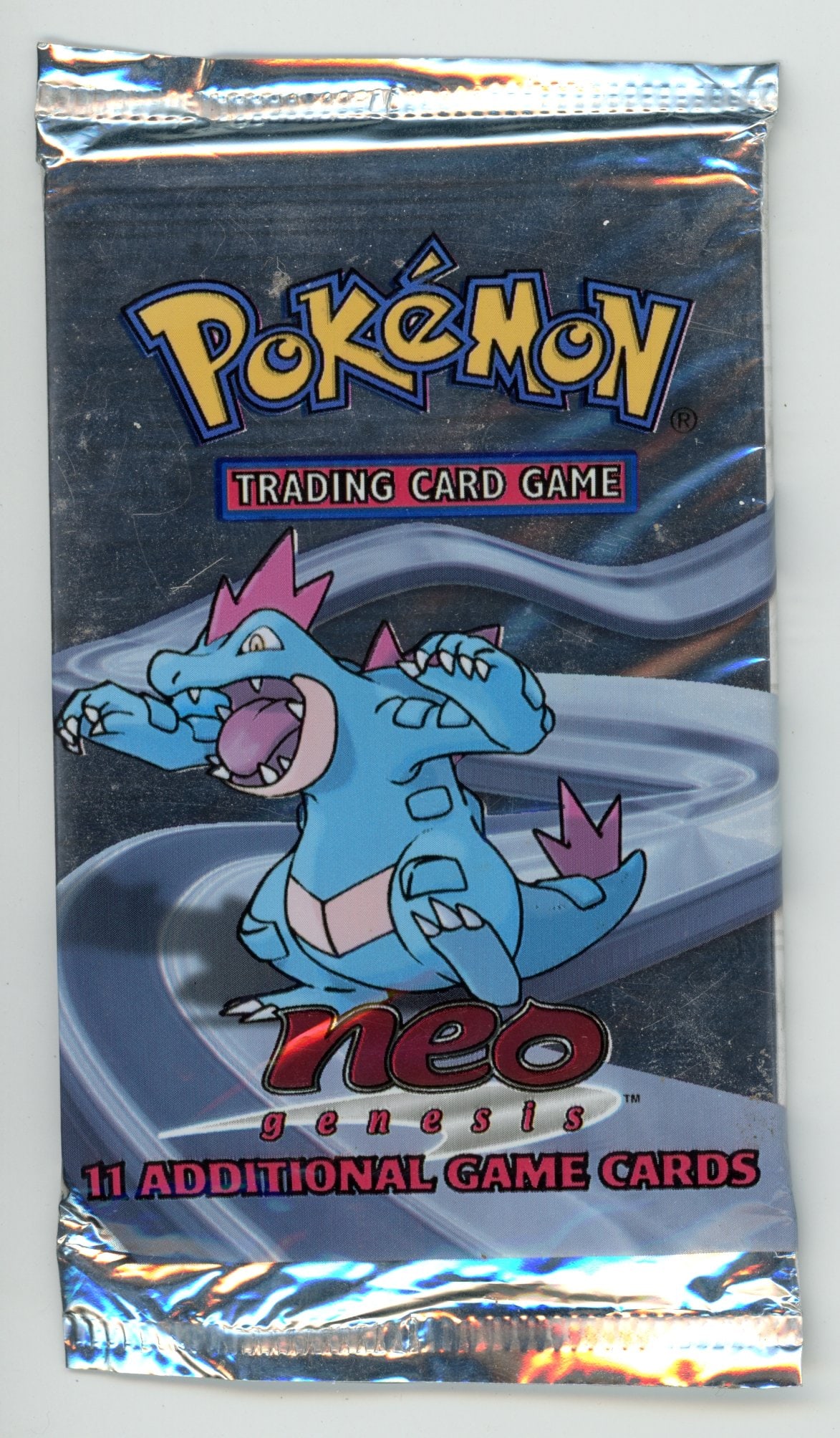 Neo Genesis Sealed Booster Pack - Feraligatr: A sealed, unweighed booster pack from the Neo Genesis expansion featuring the Feraligatr artwork in excellent condition. While light scuffing and creases can be seen, the pack has all original seals
