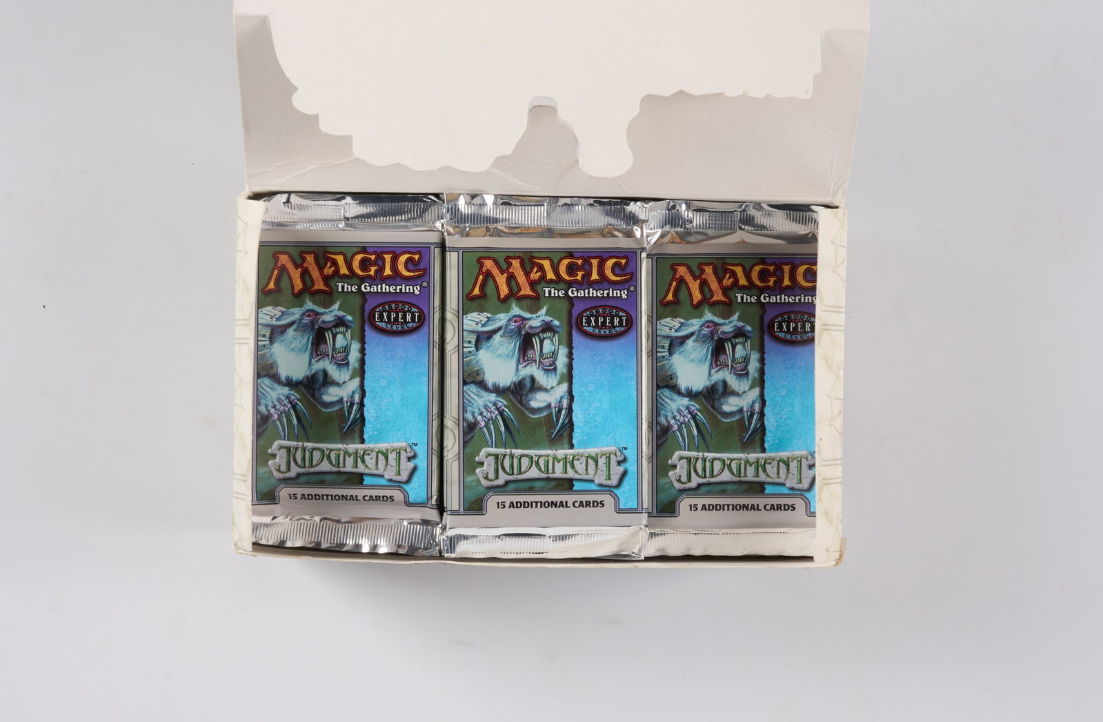 Judgment Booster Box - Opened (x35 Boosters): This opened booster box of Judgment, the 26th Magic expansion released on May 27, 2002, contains x35 sealed booster packs in factory fresh condition. The box has rips, pen and tape marks, but the boos