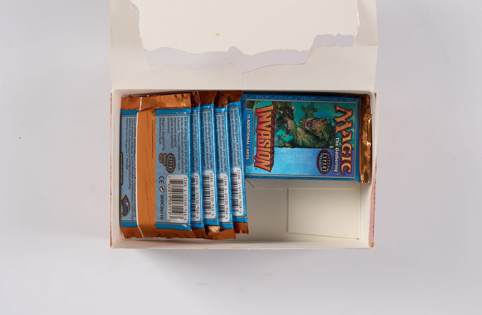 Invasion Booster Box - Opened (x12 Boosters): This opened booster box of Invasion, the twenty-first Magic expansion released in October 2000, contains x12 sealed booster packs in ?factory fresh condition. The box has rips, pen and tape marks, but