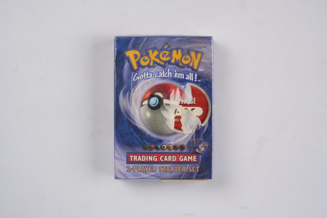 Pokémon 1999 Base Set 2-Player Starter Set - Sealed: This lot features the very first introductory product for the English language Pokémon TCG releasing in 1999.This two-player starter set includes the popular 1st Edition Machamp 1st Holo, alongside a