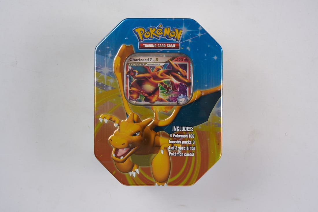 Charizard LV.X Tin - 2009 Fall Collector's Tins (Factory Sealed): A stunning Charizard LV.X Tin from 2009's Fall Collector's Tins, factory sealed and in great condition.The plastic wrapping has some very minor snags and rips, with some circular gaps that formed as p