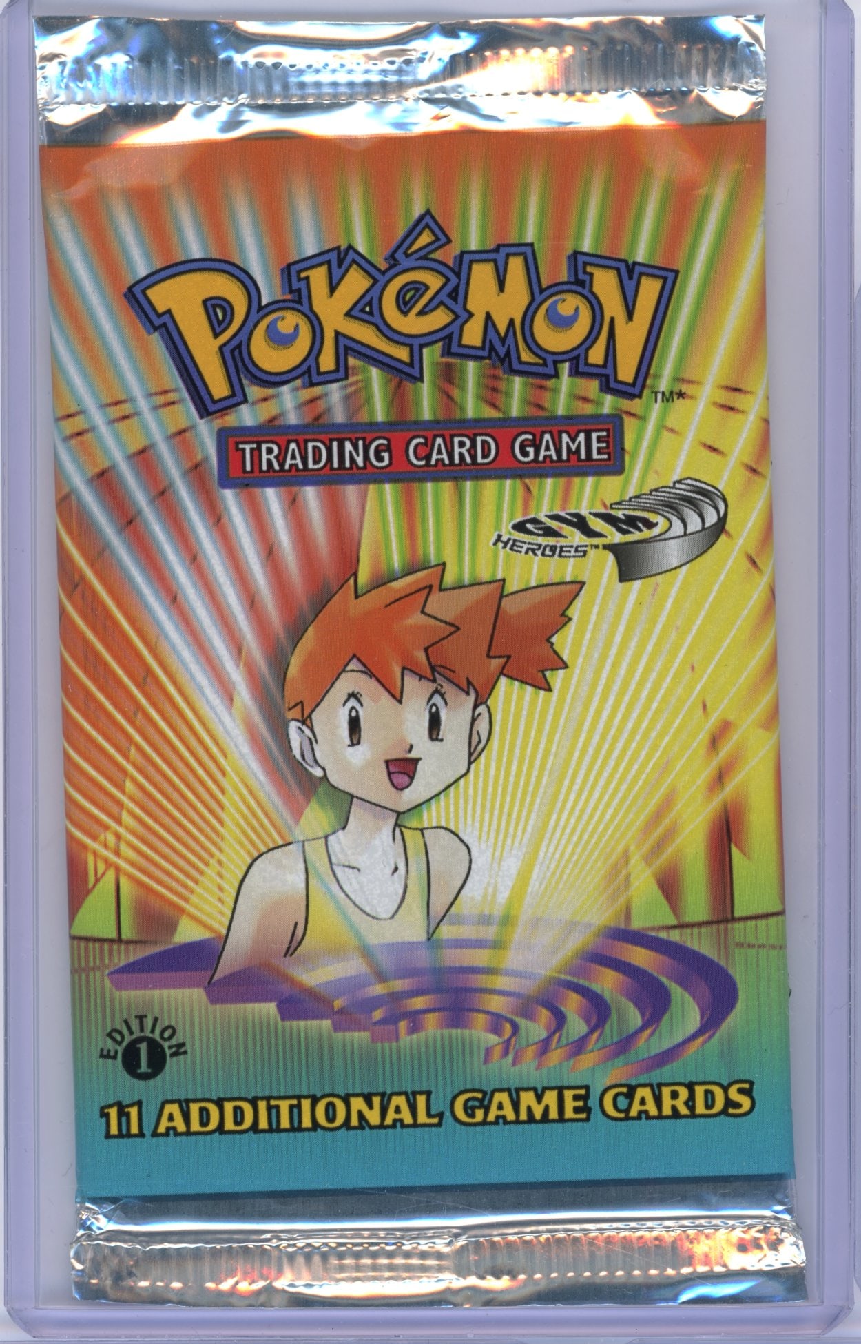 Gym Heroes 1st Edition Sealed Booster Pack - Misty Artwork (20.74g): A original Gym Heroes 1st Edition printing Sealed Booster Pack, factory sealed and in excellent condition.This pack features the Misty Artwork, and comes in at 20.74 grams.