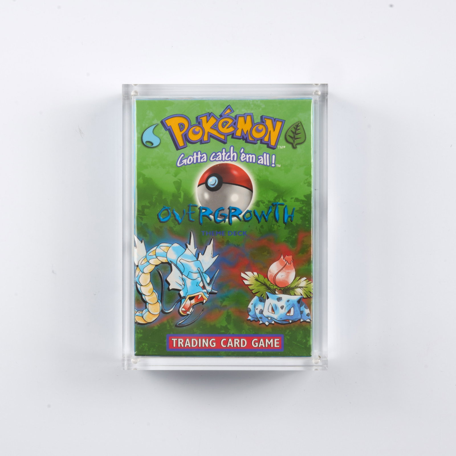 Overgrowth Theme Deck - Factory Sealed Inc. Acrylic Case: A factory sealed 'Overgrowth' Theme Deck, which includes a 60-card deck, damage counters, a custom coin, a rulebook, and a card list. Released January 9, 1999. This is a fantastic example, looking bri