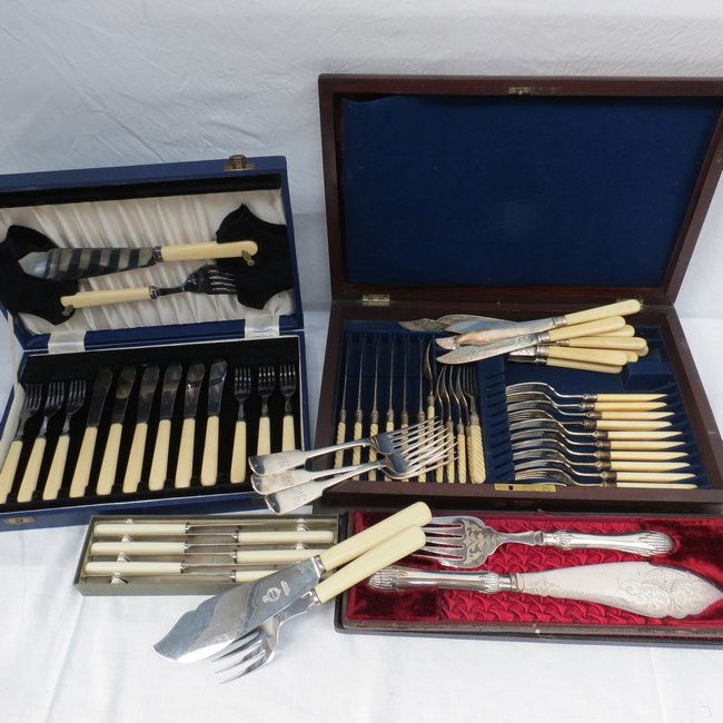 A mahogany canteen (AF) containing dessert and fish cut: A mahogany canteen (AF) containing dessert and fish cutlery and three plated table forks, as new fish knives and forks (six pieces) with servers in blue case; a pair of Victorian fish servers in case