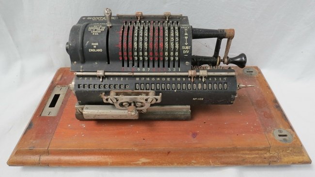 A Guy's Britannic calculating machine, in a mahogany ca: A Guy's Britannic calculating machine, in a mahogany case, 36cm wide