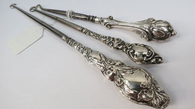 Three silver handled dressing table accessories, marked: Three silver handled dressing table accessories, marked Birmingham 1907 and other dates.