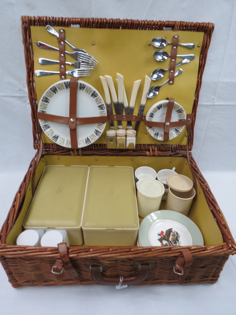 A fully fitted wicker picnic basket: A fully fitted wicker picnic basket for four with Aynsley plates in 'Sirran 96' design, also four hunting themed plates by Grindley's
