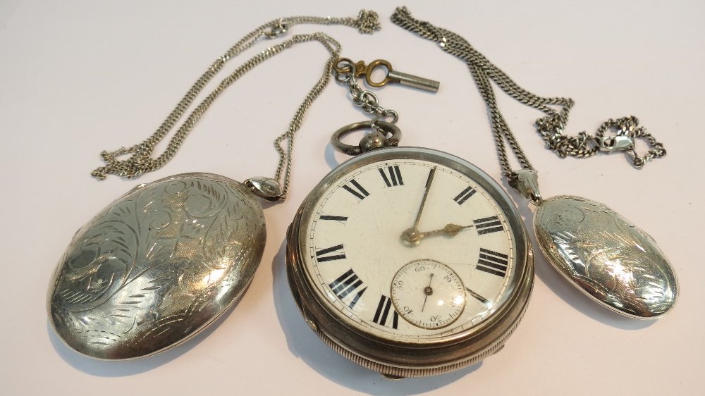 An early 20thC silver cased pocket watch: An early 20thC silver cased pocket watch with white enamel dial set out in Roman numerals with subsidiary second dial together with two silver lockets with chains.